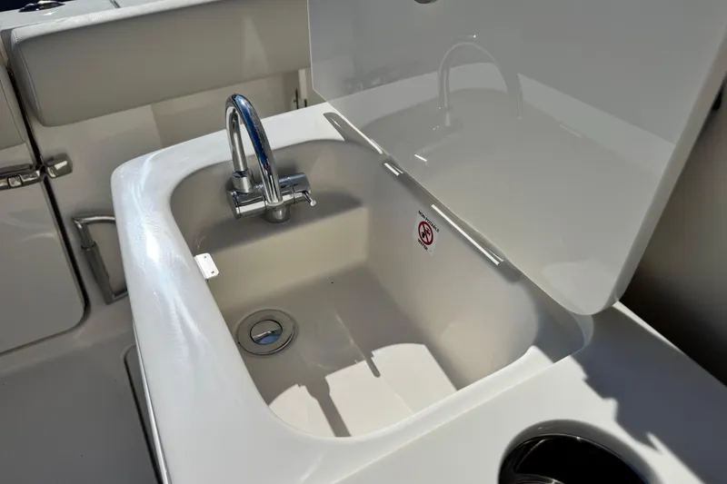 Slide: The Image of Sailfish 272 CC 2026 boat sink with faucet and cover in open position. - 15