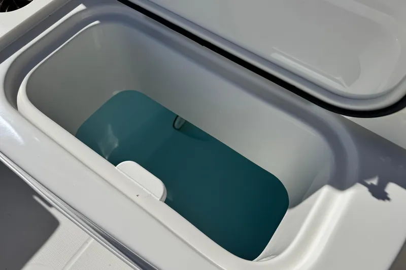 Slide: The Image of Open storage compartment on 2026 Sailfish 272 CC boat, showing interior space. - 16