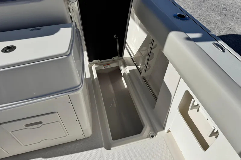 Slide: The Image of 2026 Sailfish 272 CC boat interior with storage compartments and seating area. - 18
