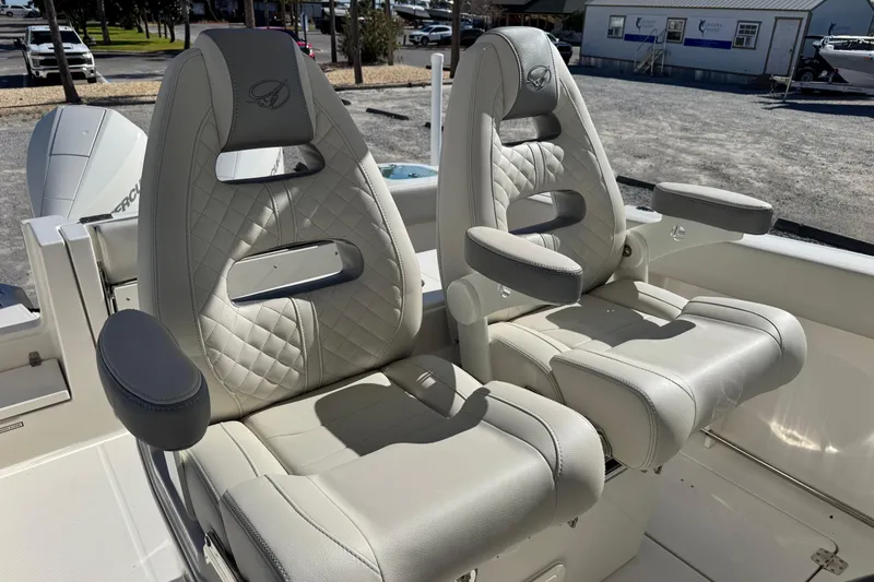 Slide: The Image of Luxurious seating on 2026 Sailfish 272 CC boat, featuring plush, quilted design and armrests. - 20