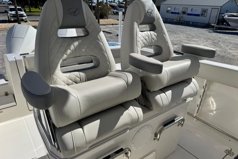 Slide: The Image of Luxurious seating on 2026 Sailfish 272 CC boat, featuring plush, quilted design and armrests. - 21