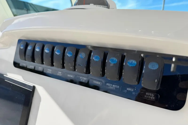 Slide: The Image of Control panel of 2026 Sailfish 272 CC boat with labeled switches. - 22