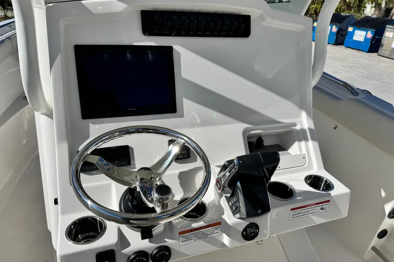 Slide: The Image of 2026 Sailfish 272 CC boat dashboard with steering wheel and control panel. - 27