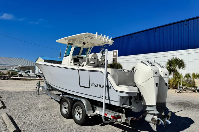 Slide: The Image of 2026 Sailfish 272 CC boat on trailer, dual engines, parked outdoors. - 3