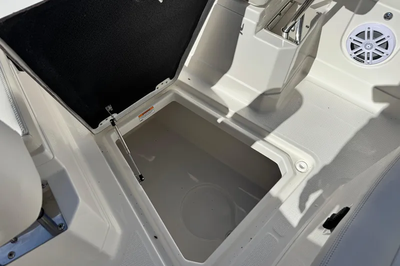 Slide: The Image of 2026 Sailfish 272 CC boat storage compartment with open hatch and speaker. - 34