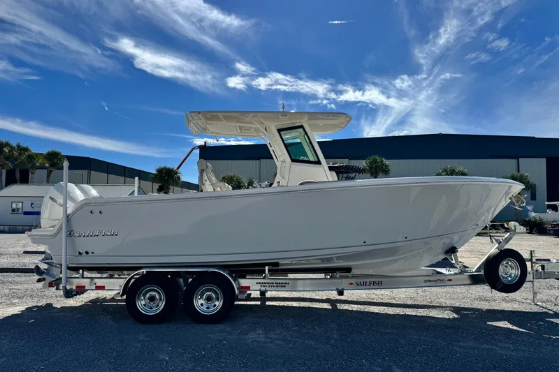 Slide: The Image of 2026 Sailfish 272 CC boat on trailer under clear blue sky. - 6