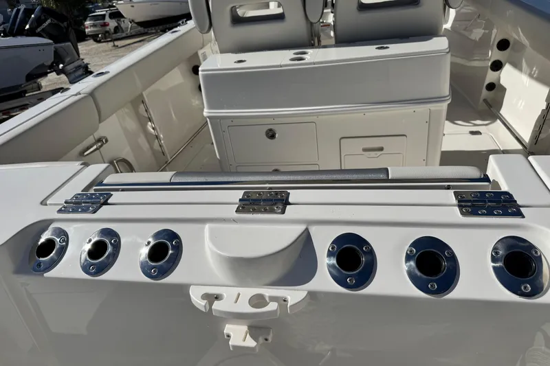 Slide: The Image of 2026 Sailfish 272 CC boat interior with rod holders and storage compartments. - 9