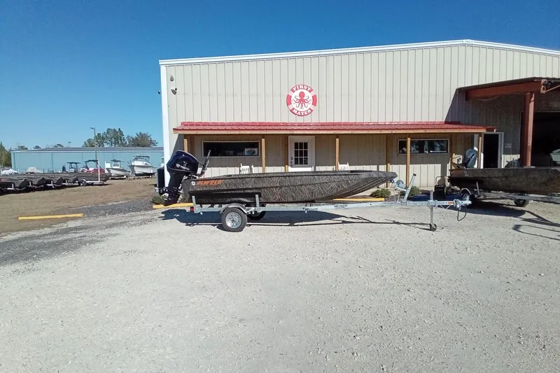 Slide: The Image of 2026 Alweld 1552 Invader boat on trailer outside a warehouse. - 3