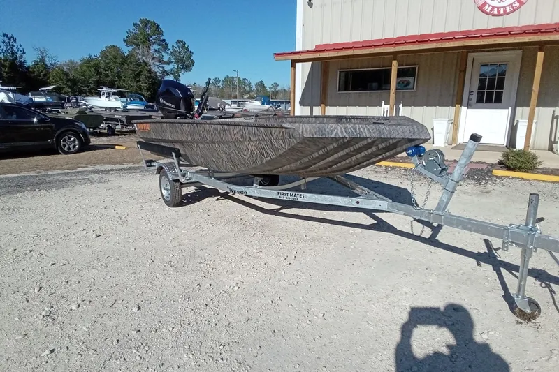 Slide: The Image of 2026 Alweld 1552 Invader boat on trailer, parked outside a building. - 4