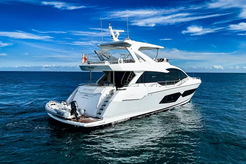 Slide: The Image of 2019 Sunseeker 76 Yacht cruising on open sea under clear blue sky. - 11