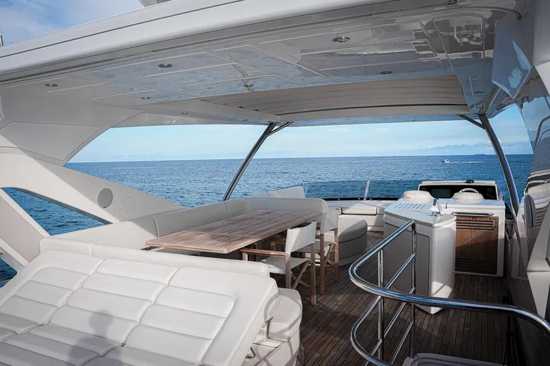 Slide: The Image of Luxurious 2019 Sunseeker 76 Yacht deck with seating, dining area, and ocean view. - 12