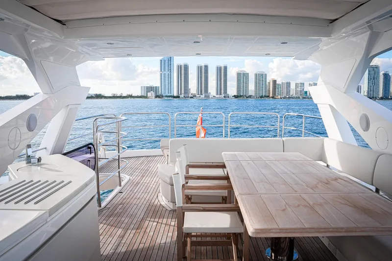 Slide: The Image of Luxurious 2019 Sunseeker 76 Yacht deck with city skyline view. - 16
