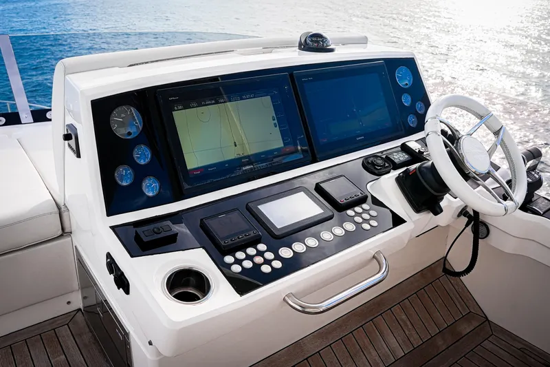 Slide: The Image of 2019 Sunseeker 76 Yacht helm with advanced navigation displays and controls. - 20