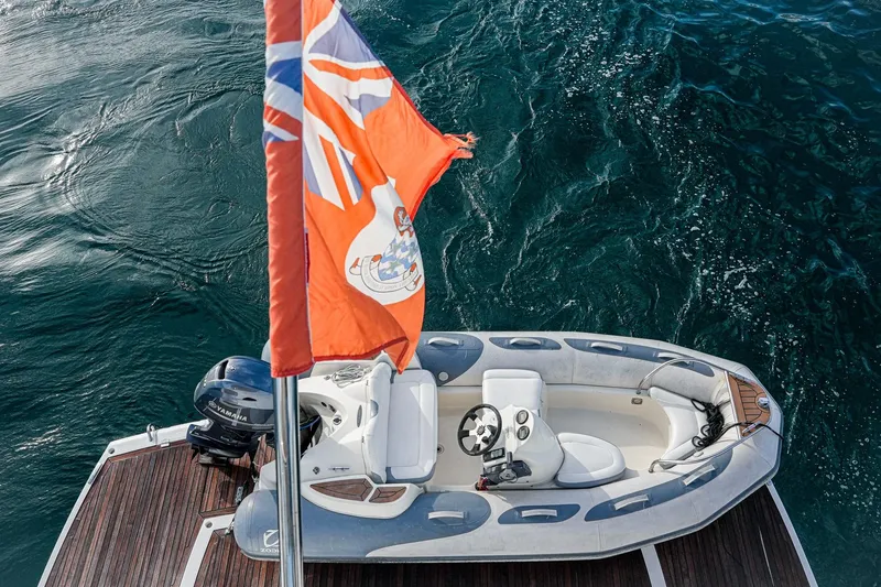 Slide: The Image of Aerial view of a Sunseeker 76 Yacht's tender boat with flag, 2019 model. - 21