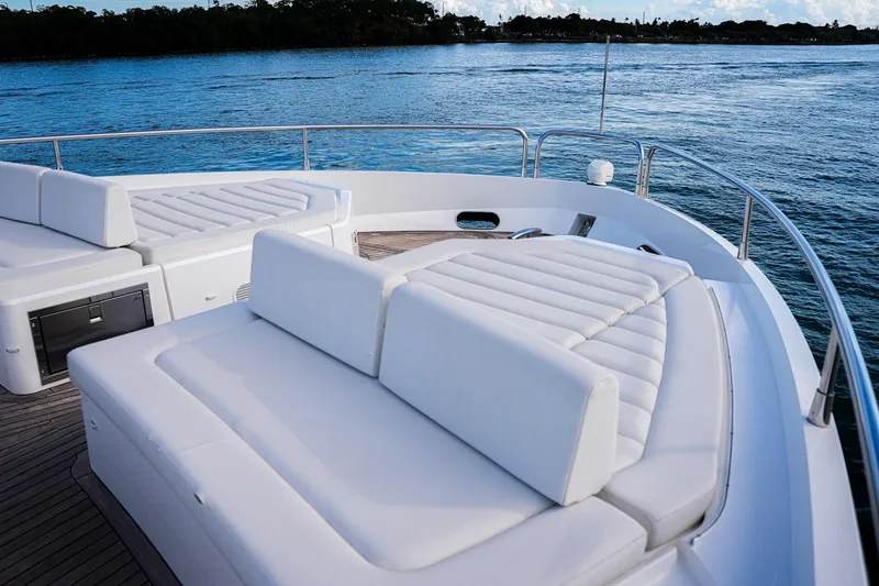 Slide: The Image of Luxurious 2019 Sunseeker 76 Yacht with elegant white seating on deck. - 26
