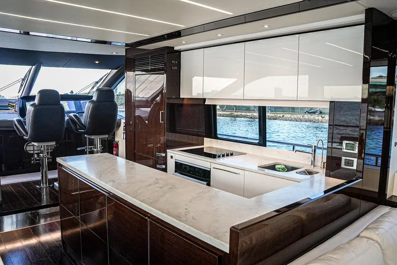 Slide: The Image of Luxurious interior of 2019 Sunseeker 76 Yacht with modern kitchen and helm station. - 32