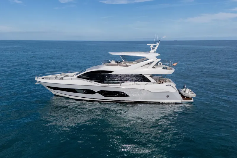 Slide: The Image of 2019 Sunseeker 76 Yacht cruising on open sea under clear blue sky. - 5