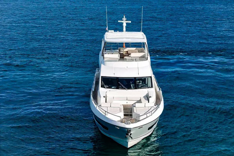 Slide: The Image of 2019 Sunseeker 76 Yacht on open blue sea, front view. - 9