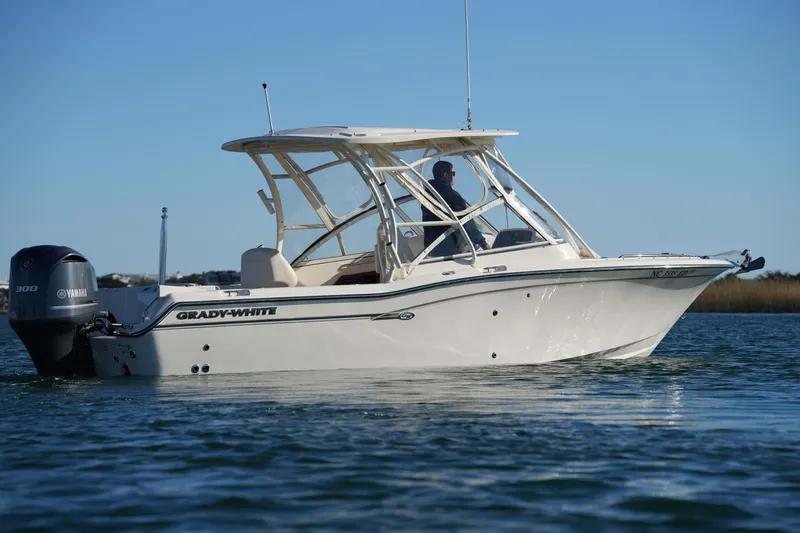 Slide: The Image of 2016 Grady-White Freedom 255 boat on water, side view, with Yamaha engine. - 10