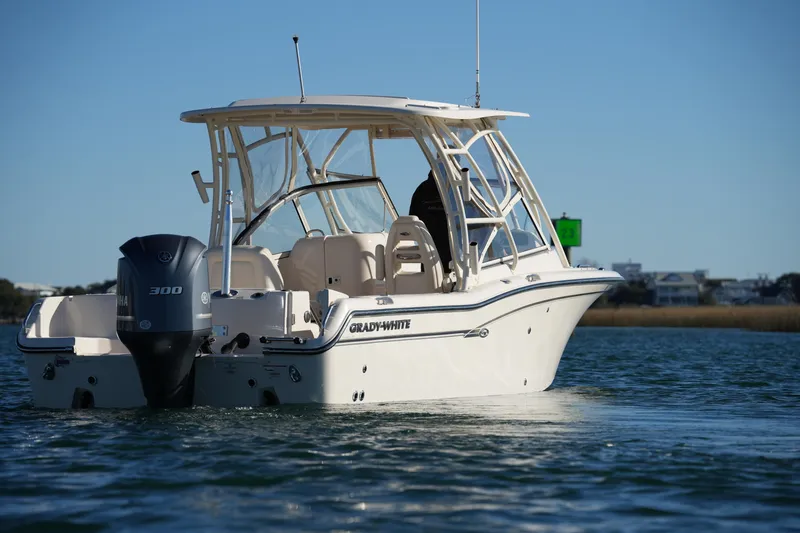 Slide: The Image of 2016 Grady-White Freedom 255 boat on water, featuring Yamaha 300 engine. - 12