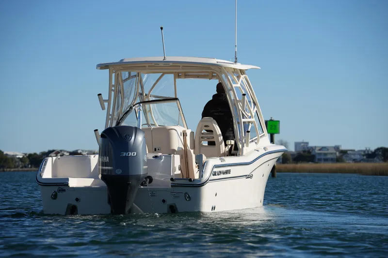 Slide: The Image of 2016 Grady-White Freedom 255 boat with Yamaha 300 engine on calm water. - 13