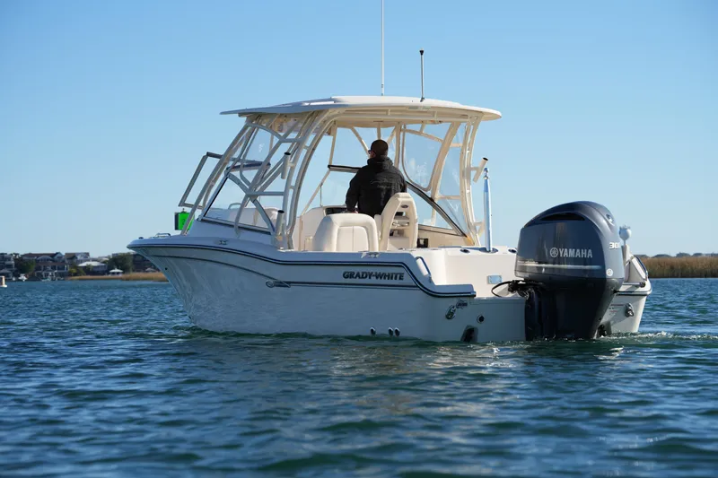 Slide: The Image of 2016 Grady-White Freedom 255 boat on water with Yamaha engine. - 16