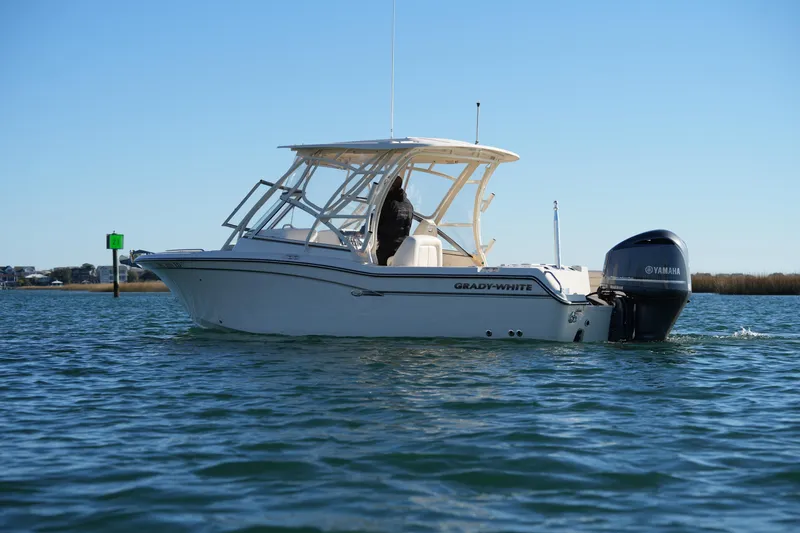 Slide: The Image of 2016 Grady-White Freedom 255 boat on water with Yamaha engine. - 17
