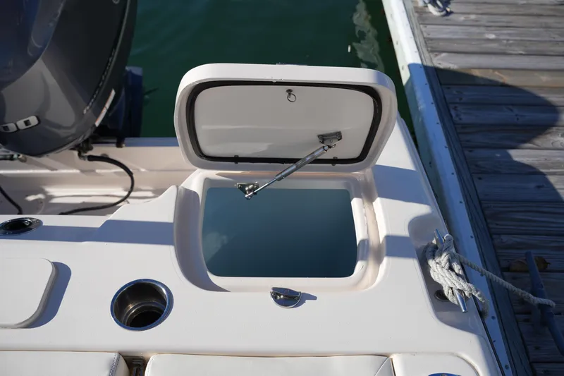 Slide: The Image of 2016 Grady-White Freedom 255 boat with open storage compartment by the dock. - 20