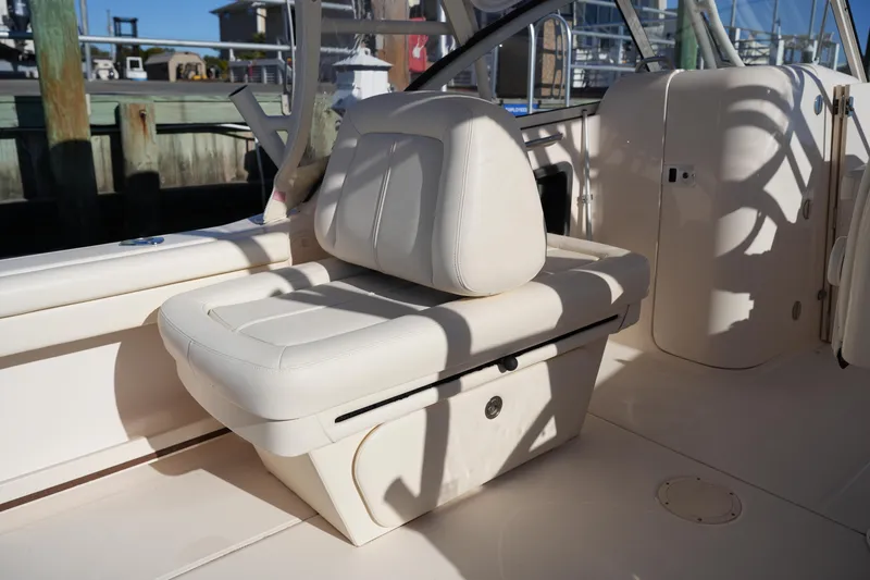 Slide: The Image of 2016 Grady-White Freedom 255 boat interior with cushioned seating and storage. - 21