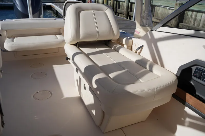 Slide: The Image of 2016 Grady-White Freedom 255 boat interior with beige seating and console. - 22