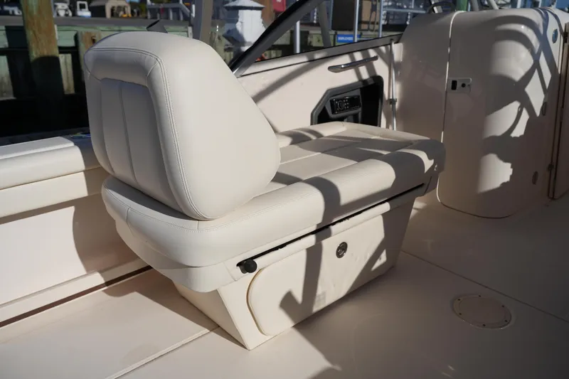 Slide: The Image of 2016 Grady-White Freedom 255 boat interior with cushioned seating and storage. - 23