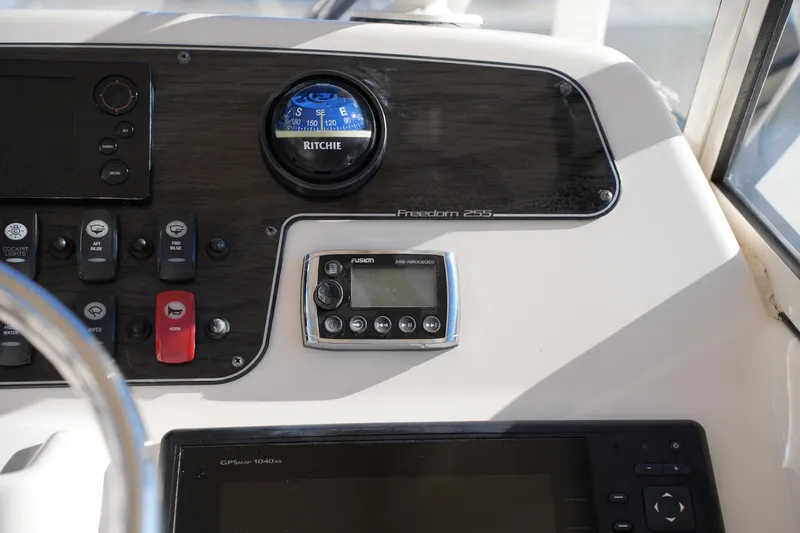 Slide: The Image of 2016 Grady-White Freedom 255 dashboard with navigation instruments and controls. - 30