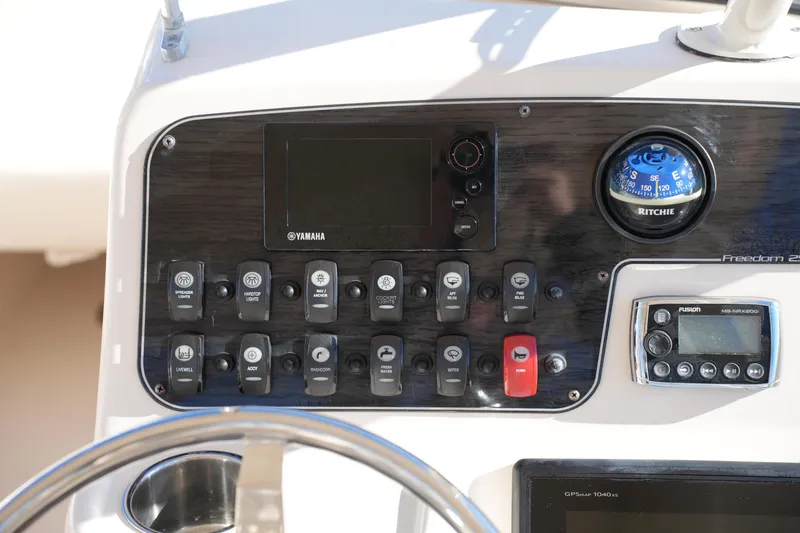Slide: The Image of Control panel of 2016 Grady-White Freedom 255 boat with Yamaha and Ritchie components. - 31