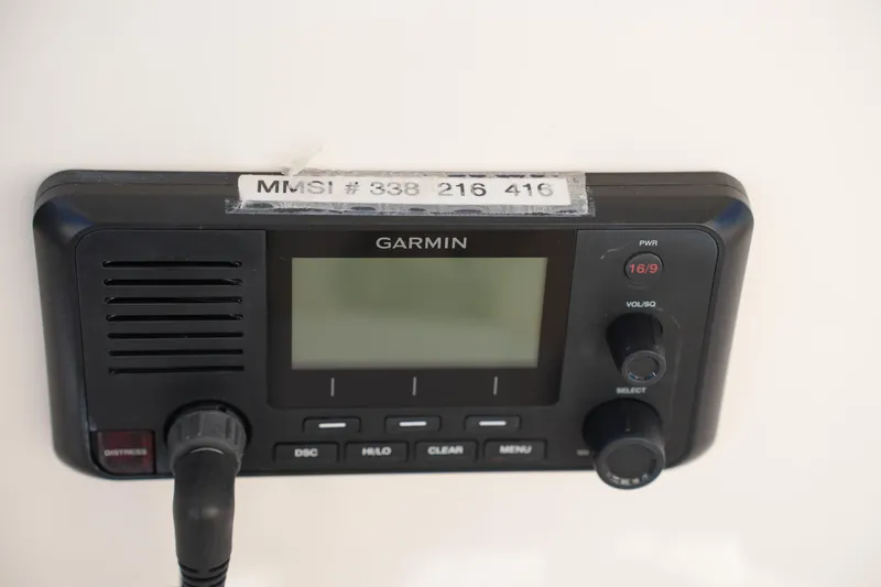 Slide: The Image of Garmin marine radio on 2016 Grady-White Freedom 255 boat, displaying MMSI number. - 32