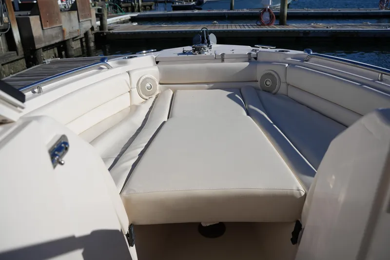 Slide: The Image of 2016 Grady-White Freedom 255 boat interior with cushioned seating and dock view. - 37