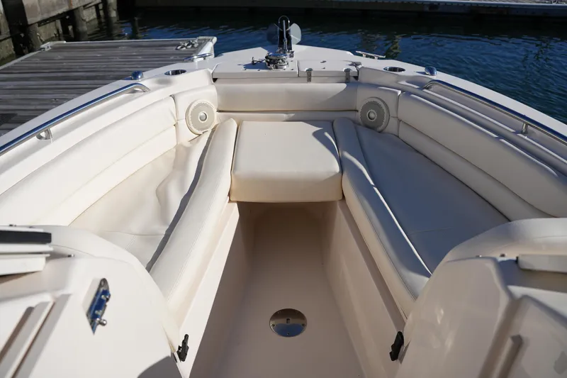 Slide: The Image of 2016 Grady-White Freedom 255 boat interior with cushioned seating and dock view. - 38