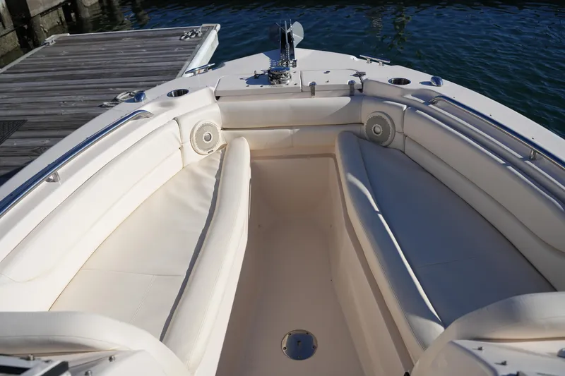Slide: The Image of 2016 Grady-White Freedom 255 boat interior with cushioned seating and dockside view. - 40