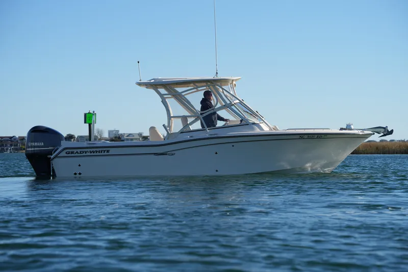 Slide: The Image of 2016 Grady-White Freedom 255 boat on calm water, side view. - 7