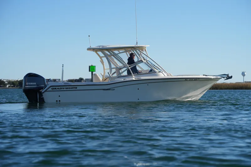 Slide: The Image of 2016 Grady-White Freedom 255 boat on calm water with Yamaha engine. - 8