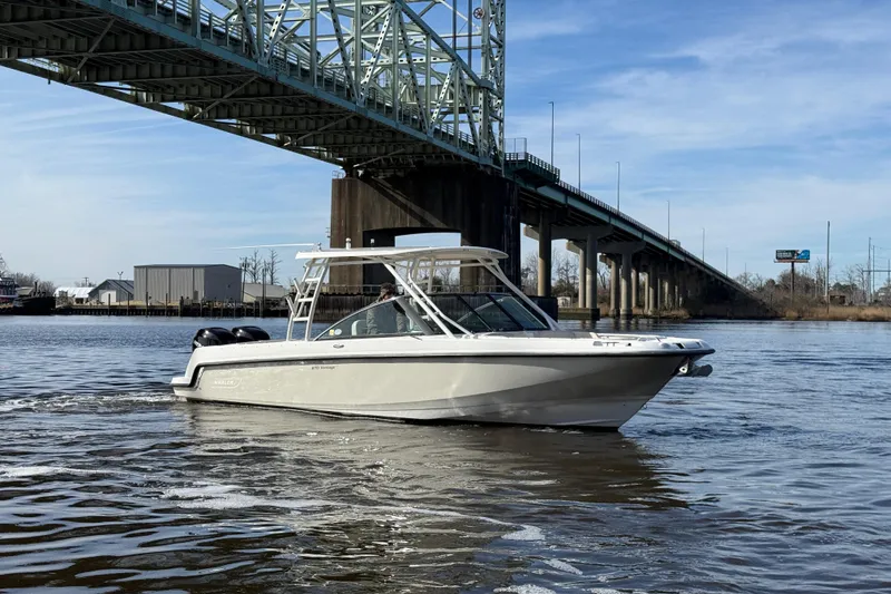 Slide: The Image of 2014 Boston Whaler 270 Vantage boat cruising under a bridge on a sunny day. - 3