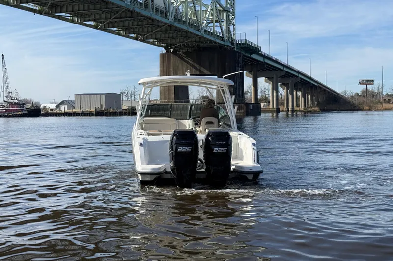 Slide: The Image of 2014 Boston Whaler 270 Vantage boat cruising under a bridge on a sunny day. - 7
