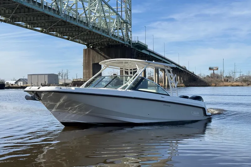 Slide: The Image of 2014 Boston Whaler 270 Vantage boat cruising under a bridge on a sunny day. - 8