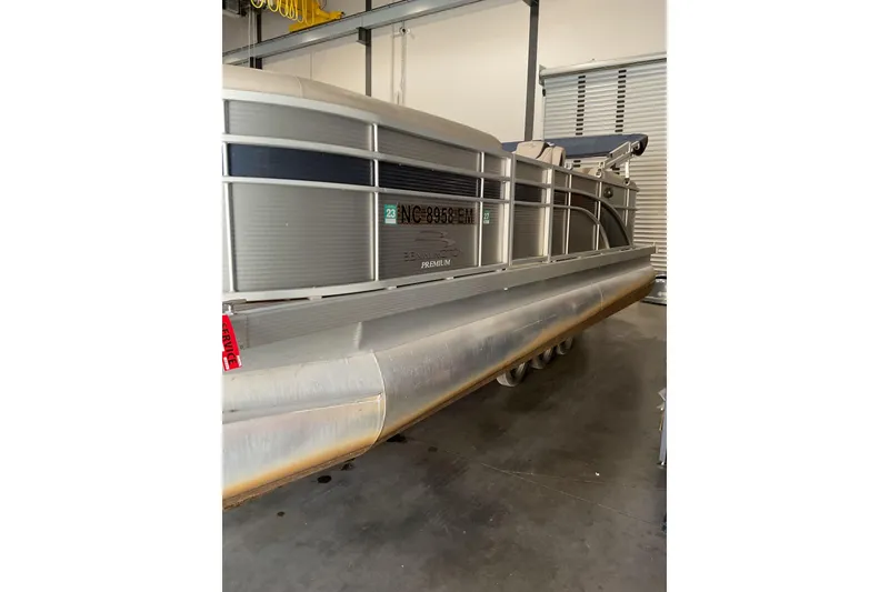 Slide: The Image of 2019 Bennington SX 23 SSRXP pontoon boat in storage, side view. - 2