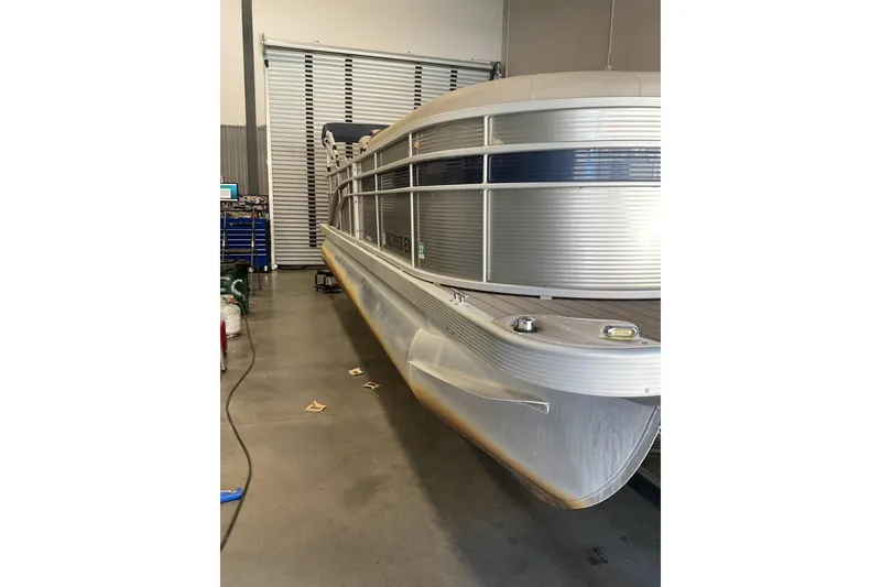 Slide: The Image of 2019 Bennington SX 23 SSRXP pontoon boat in a garage setting. - 3