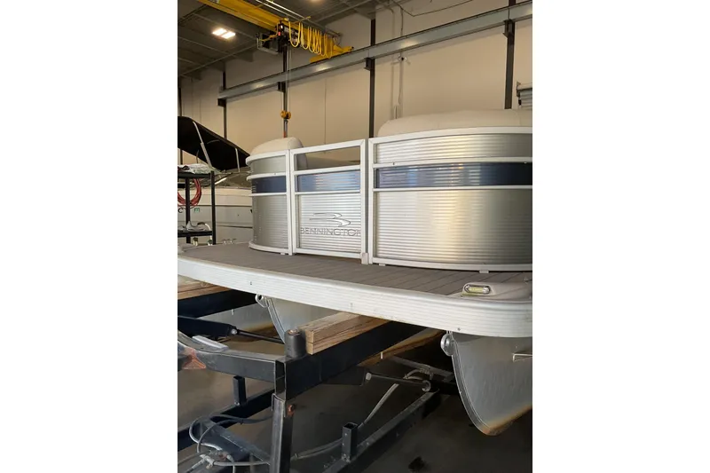 Slide: The Image of 2019 Bennington SX 23 SSRXP pontoon boat in a storage facility. - 7