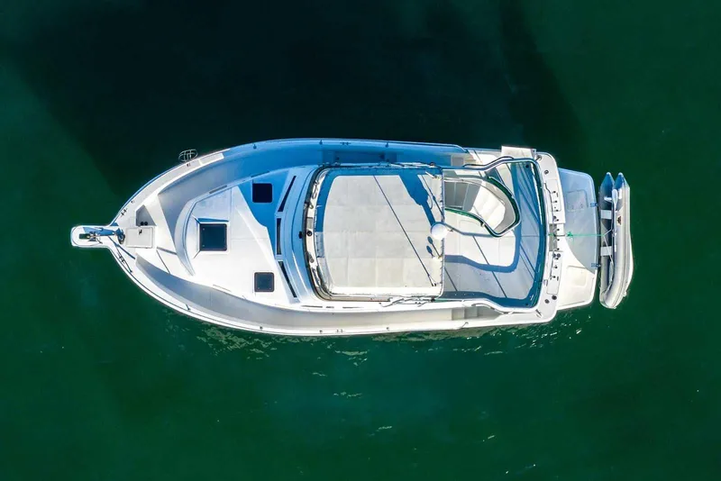 Slide: The Image of Aerial view of 1997 Mainship 350 Trawler on calm green water. - 10