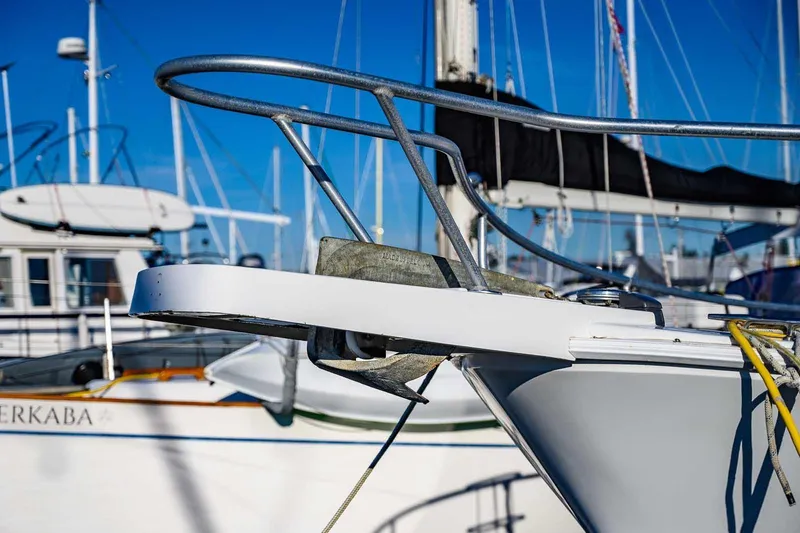 Slide: The Image of Close-up of a 1997 Mainship 350 Trawler's bow with marina background. - 13