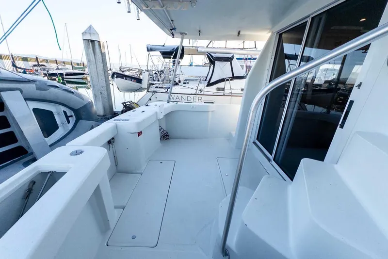 Slide: The Image of 1997 Mainship 350 Trawler deck with marina view, featuring clean white surfaces and railing. - 15