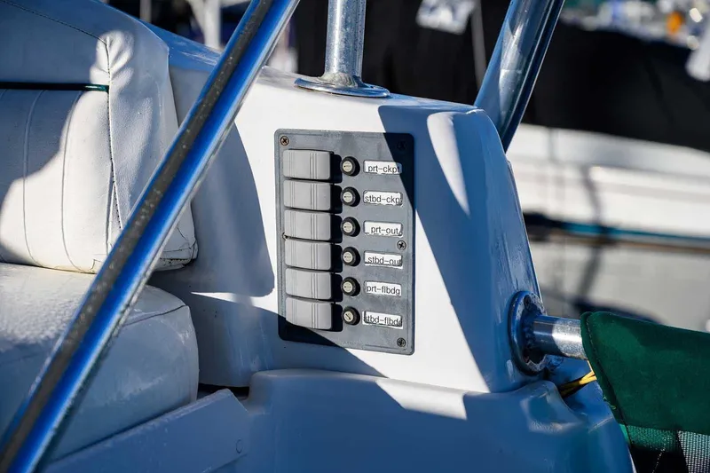Slide: The Image of Control panel on a 1997 Mainship 350 Trawler boat, featuring labeled switches. - 21