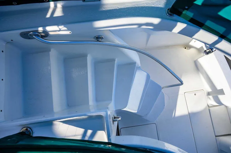 Slide: The Image of Staircase on 1997 Mainship 350 Trawler, featuring white steps and metal railing. - 22
